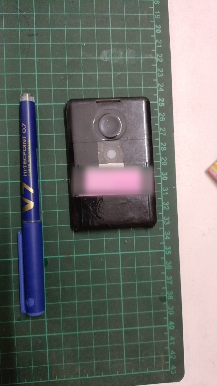 Compact sealed mesh node laid on a cutting mat next to a pen for size comparison
